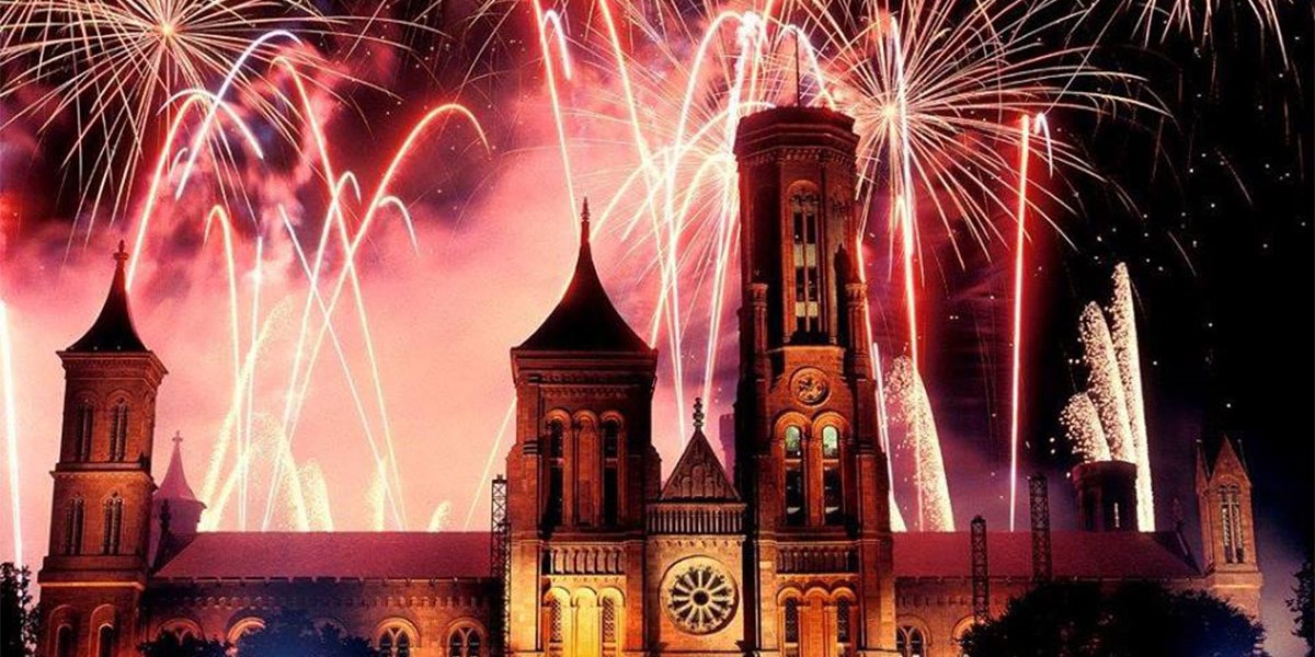 Smithsonian castle with fireworks in the background